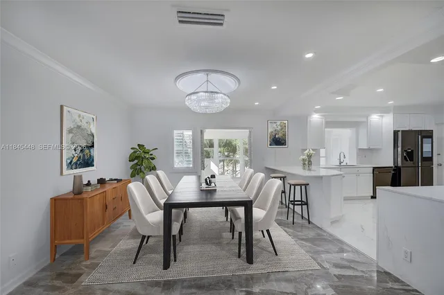 a view of a dining room with furniture and window