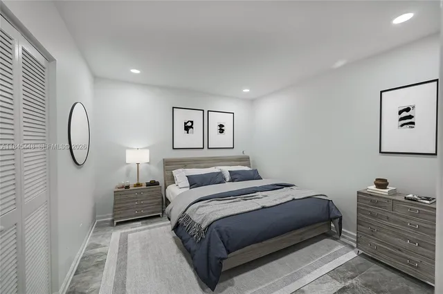 a bedroom with a bed and painting on the wall