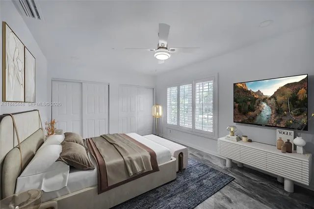 a bedroom with a large bed and a flat screen tv