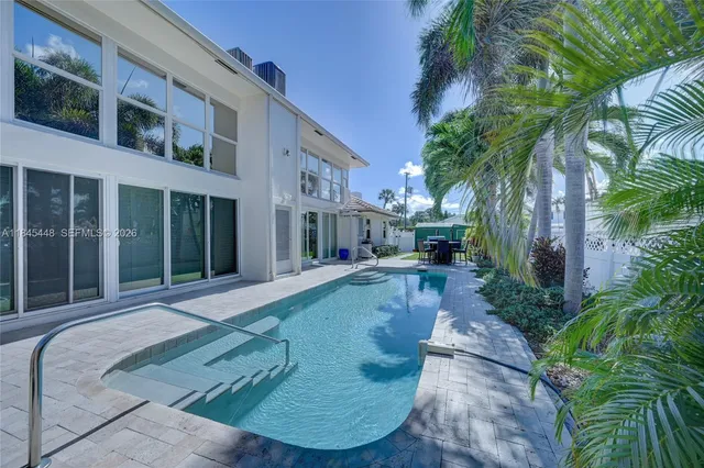 a view of a backyard with plants and porch