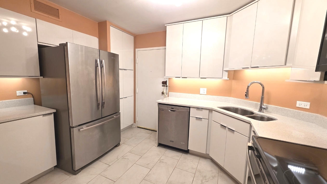 6033 North Sheridan Road, Unit 5G Chicago, IL 60660 - Photo 4 of 24 a kitchen with stainless steel appliances granite countertop a refrigerator and a sink