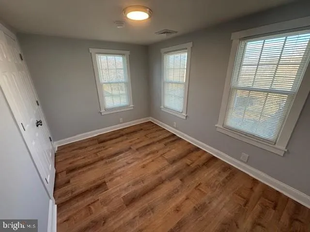 a view of room with window and hardwood floor