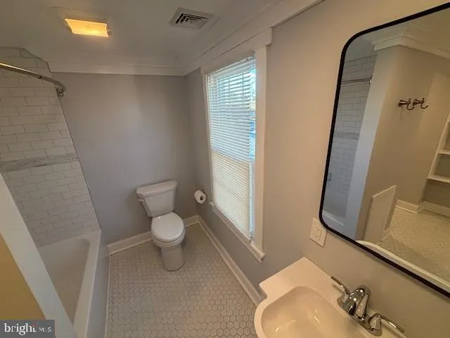 a bathroom with a toilet and a sink