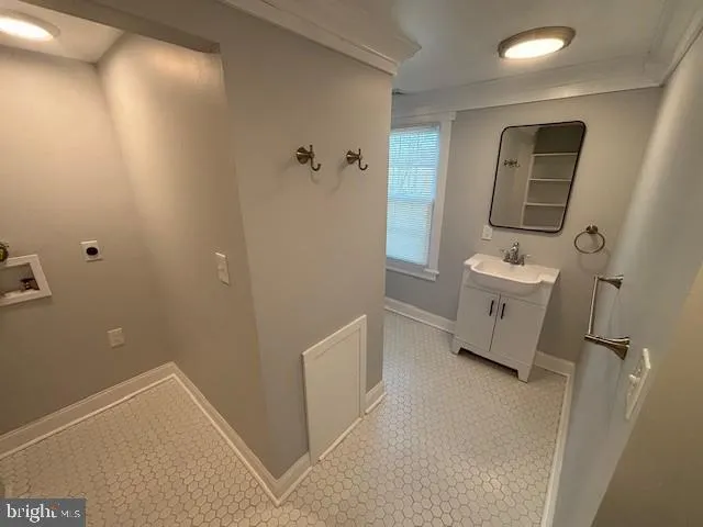 a bathroom with a sink toilet and mirror