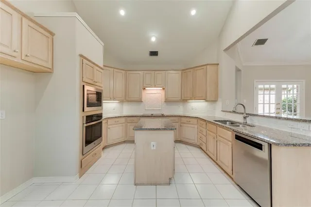 a kitchen with stainless steel appliances granite countertop a sink and cabinets