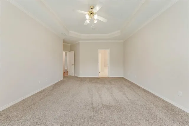 a view of a room with a ceiling fan and a window
