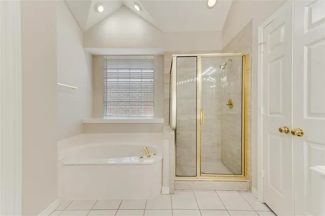 a bathroom with a granite countertop bathtub shower and toilet