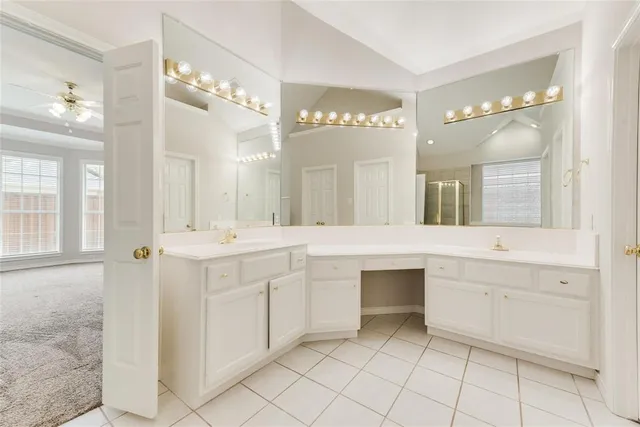 a spacious bathroom with a granite countertop sink a mirror a shower and a bathtub