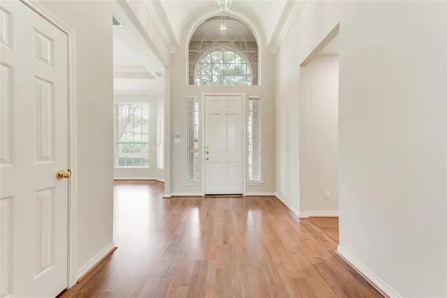 wooden floor in an empty room with a window