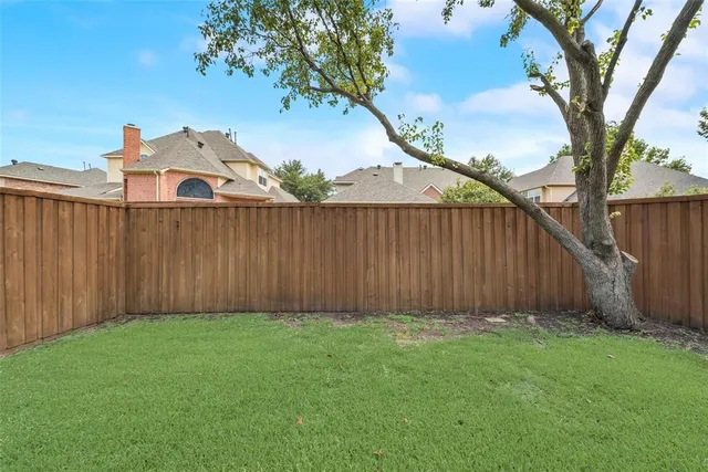a view of a backyard with a small cabin and a chair