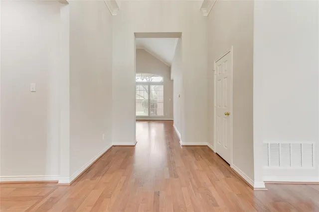 a view of a hallway with wooden floor