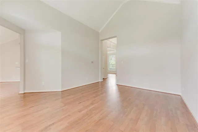 a view of an empty room and wooden floor