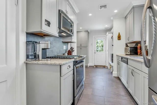 a kitchen with stainless steel appliances granite countertop a sink and cabinets
