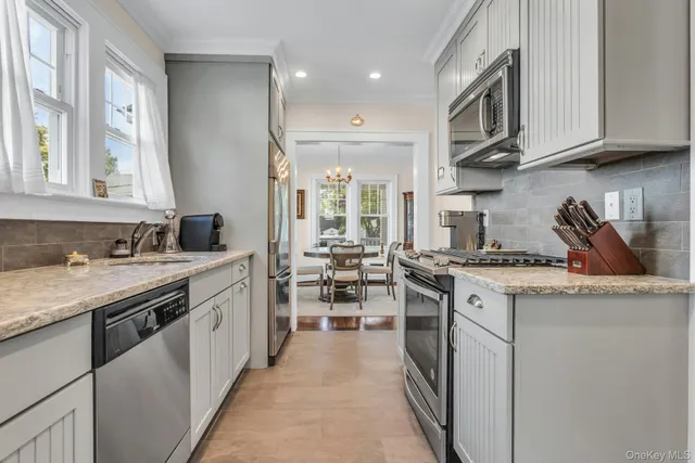 a kitchen with stainless steel appliances granite countertop a stove and cabinets