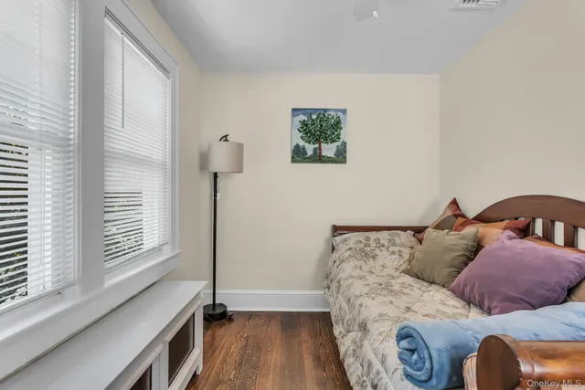 a bed sitting in a bedroom next to a window