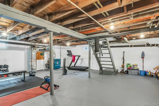 a view of a backyard with couches plants and large tree
