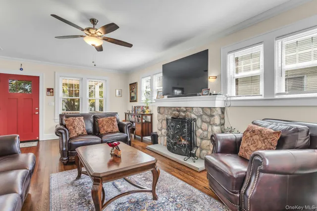 a living room with furniture a flat screen tv and a fireplace
