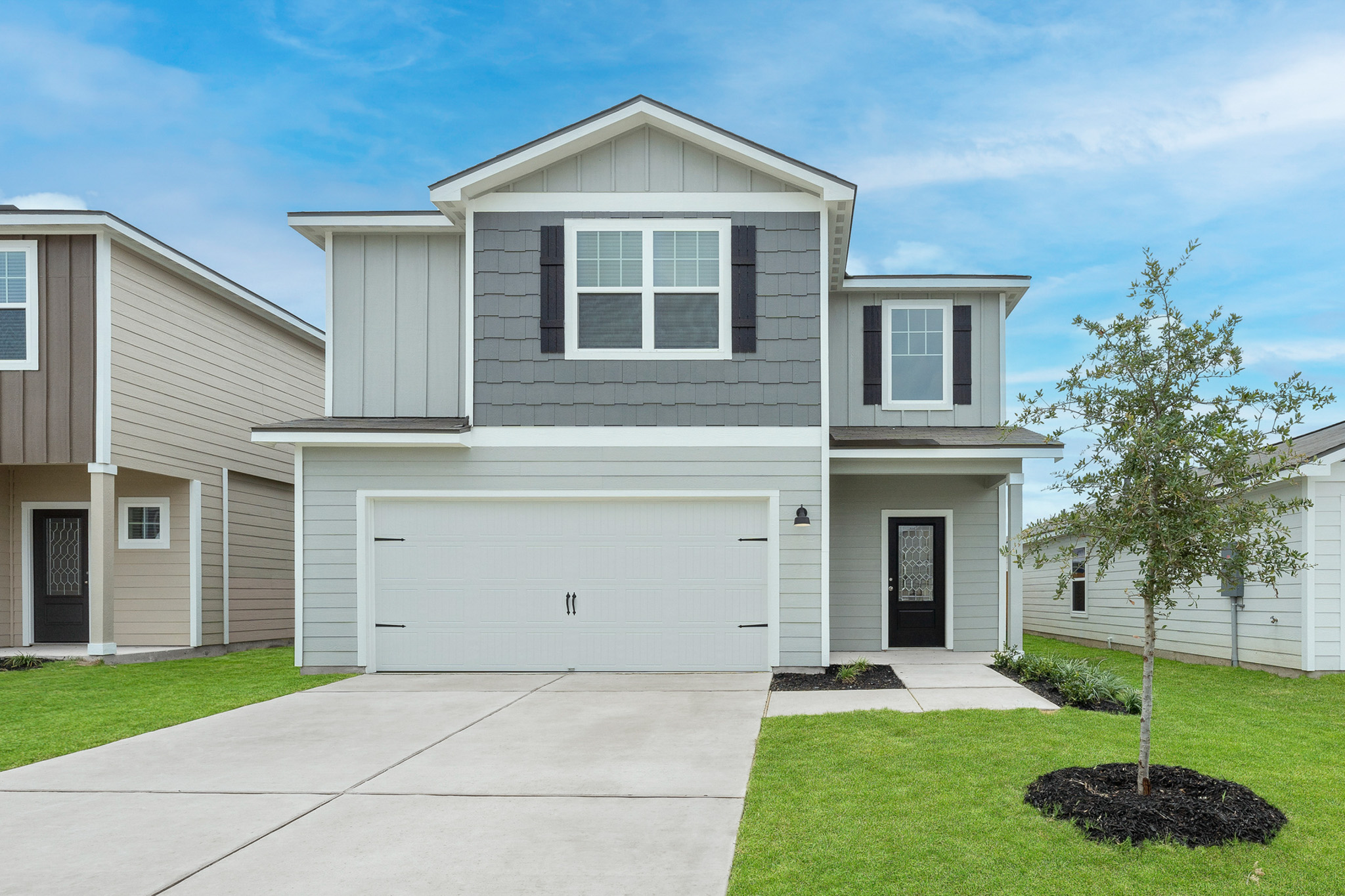 197 Fairlawn Way Maxwell, TX 78656 - Photo 1 of 14 View of front of home with a front lawn, board and batten siding, a garage, and concrete driveway