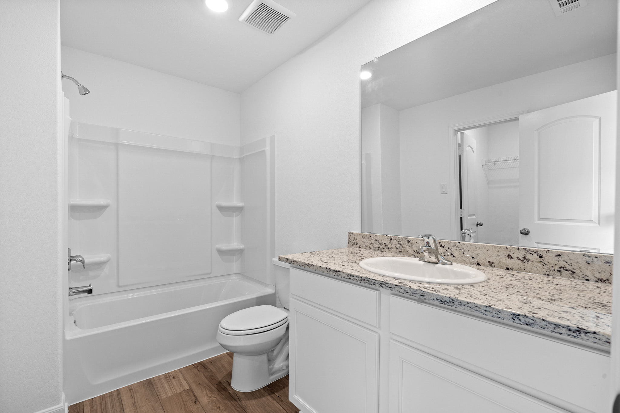 197 Fairlawn Way Maxwell, TX 78656 - Photo 13 of 14 Full bathroom featuring shower / bath combination, vanity, dark wood-type flooring, a spacious closet, and recessed lighting