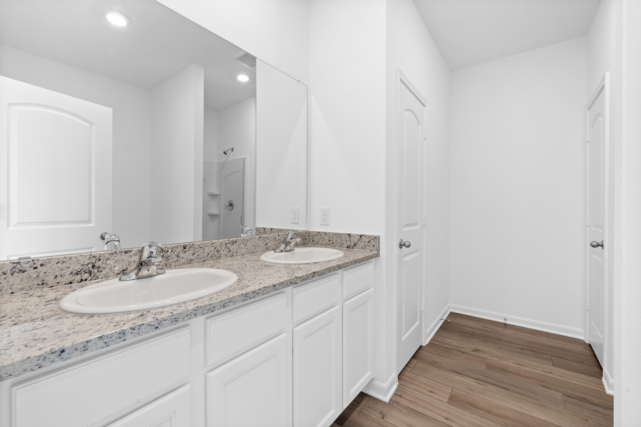 197 Fairlawn Way Maxwell, TX 78656 - Photo 7 of 14 Bathroom with double vanity, walk in shower, light wood-type flooring, and recessed lighting