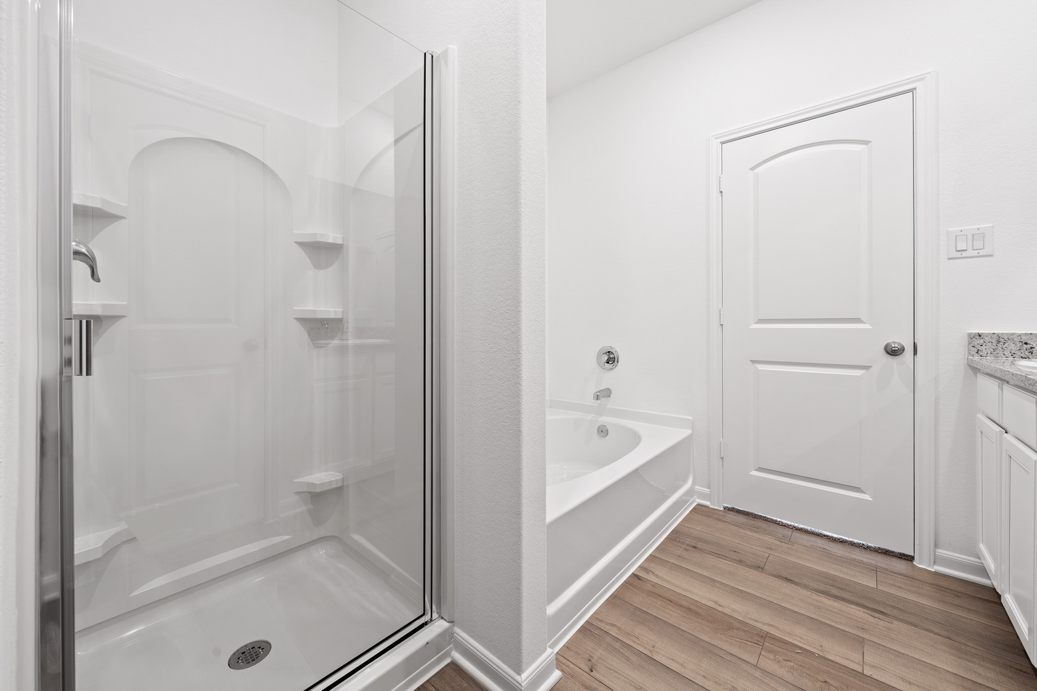 197 Fairlawn Way Maxwell, TX 78656 - Photo 8 of 14 Bathroom with vanity, light wood finished floors, a garden tub, and a stall shower