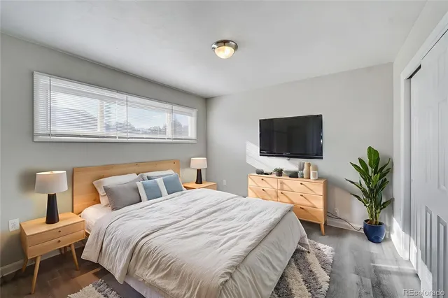 a bedroom with a bed and a flat screen tv