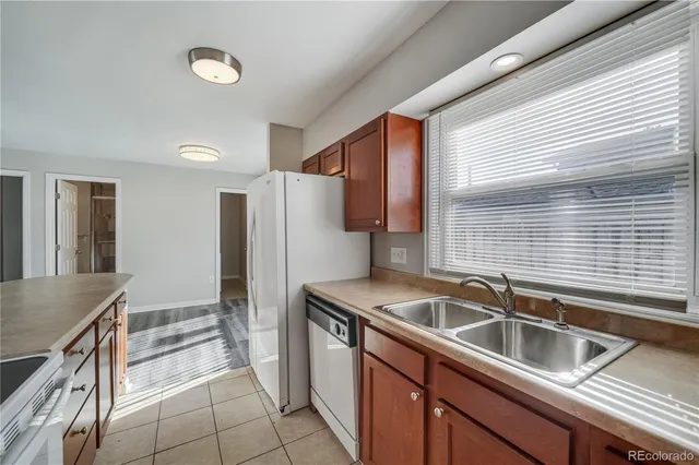 a kitchen that has a sink and a refrigerator