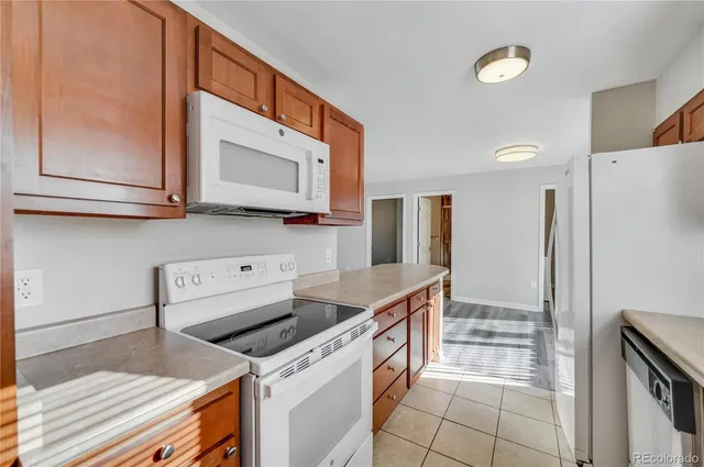 a kitchen with stainless steel appliances granite countertop a refrigerator and a stove