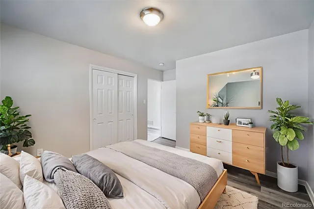 a bedroom with a bed and a potted plant