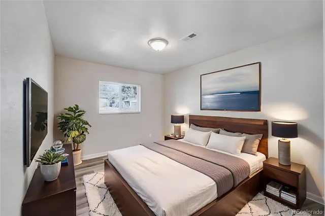 a bedroom with a bed and a potted plant