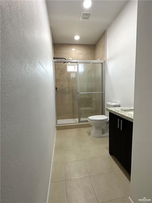 209 Rafael Drive, Unit 2 San Juan, TX 78589 - Photo 8 of 13 a bathroom with a granite countertop sink a toilet and shower