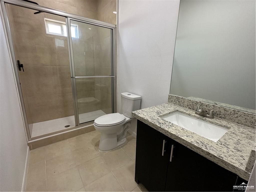 209 Rafael Drive, Unit 2 San Juan, TX 78589 - Photo 9 of 13 a bathroom with a granite countertop sink a toilet and shower