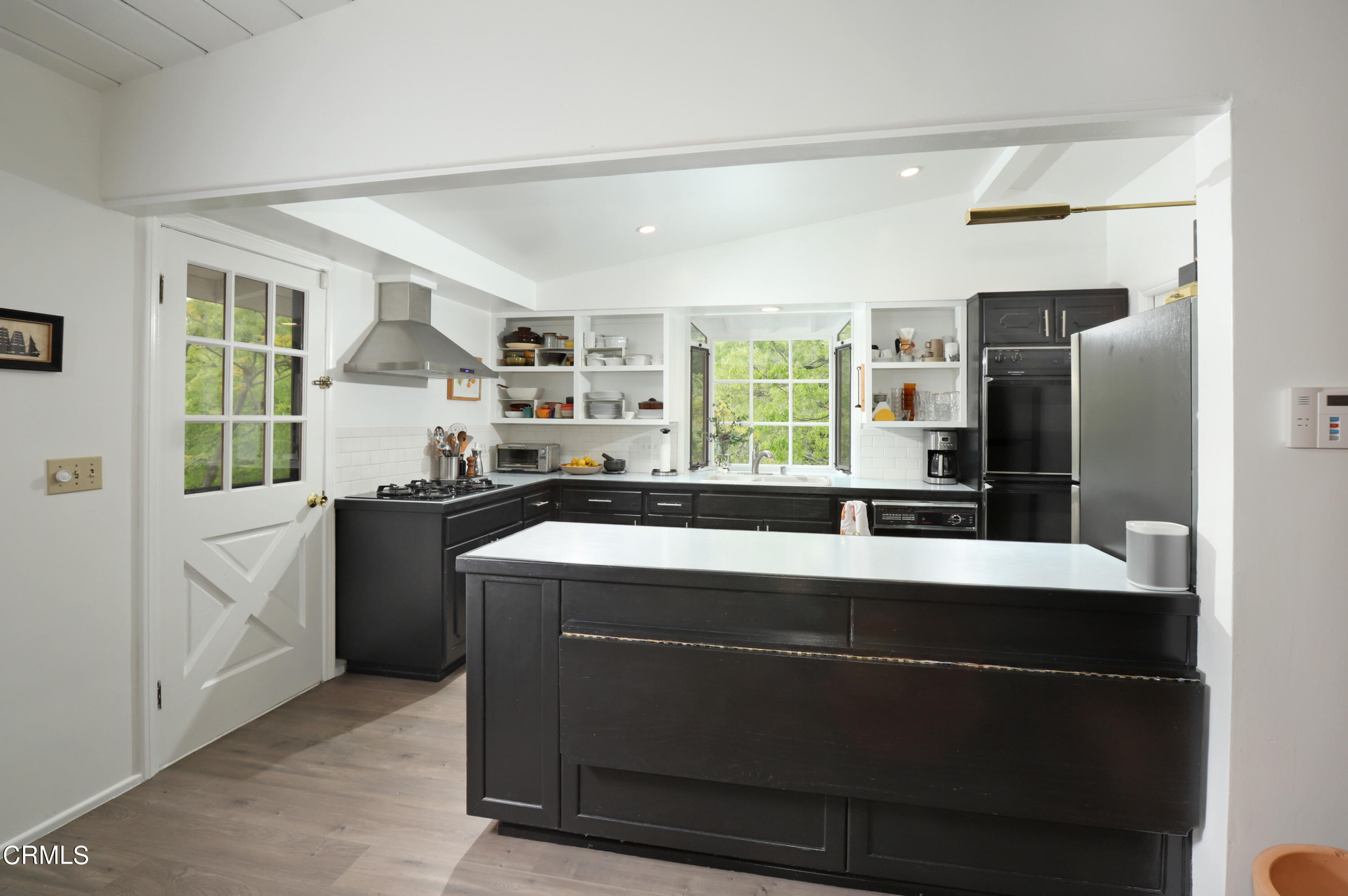 400 Glenullen Drive Pasadena, CA 91105 - Photo 5 of 19 a kitchen with kitchen island a counter top space a sink stainless steel appliances and cabinets