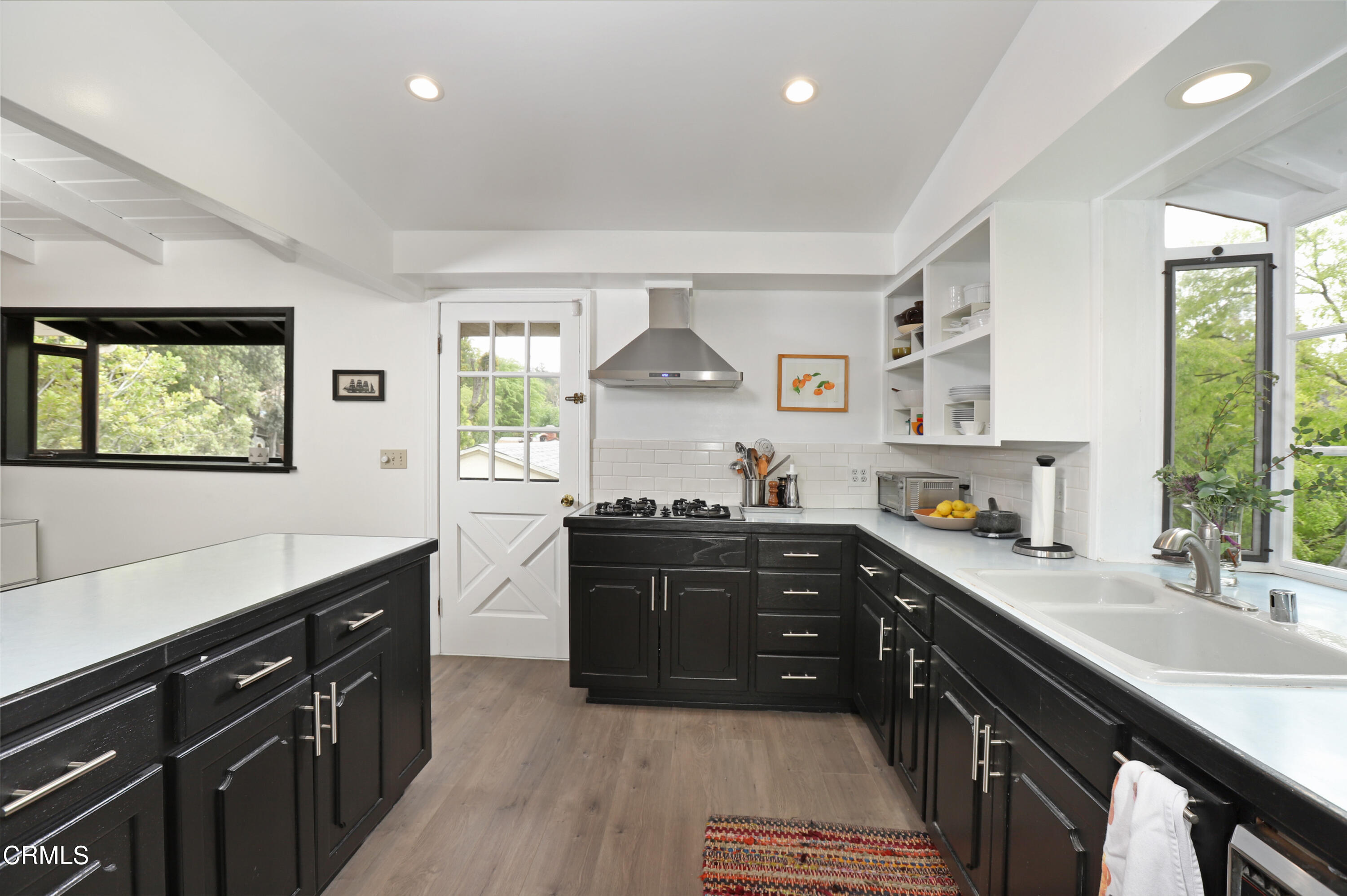 400 Glenullen Drive Pasadena, CA 91105 - Photo 6 of 19 a kitchen with stainless steel appliances granite countertop a sink stove and cabinets