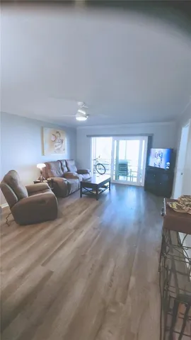 a living room with lots of furniture and a wooden floor
