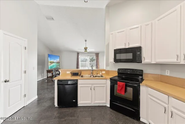 a kitchen with stainless steel appliances a stove microwave and cabinets