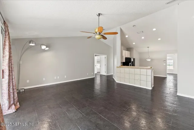 an empty room with closet and windows