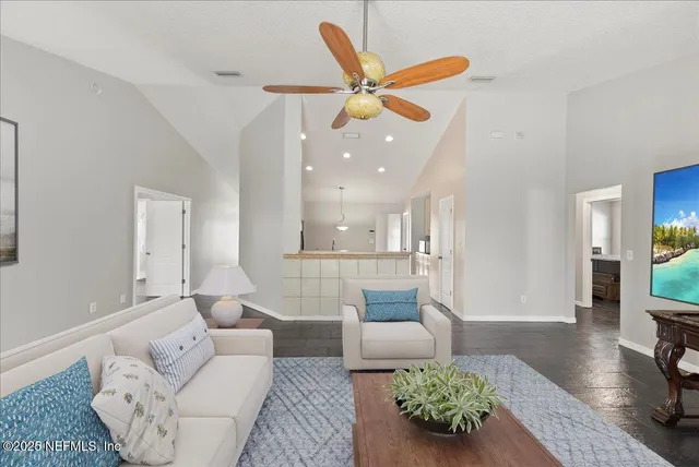 a living room with furniture and a ceiling fan