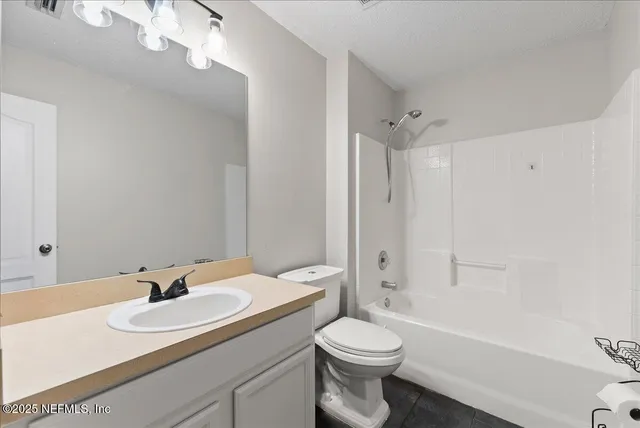 a bedroom with a bed and a television