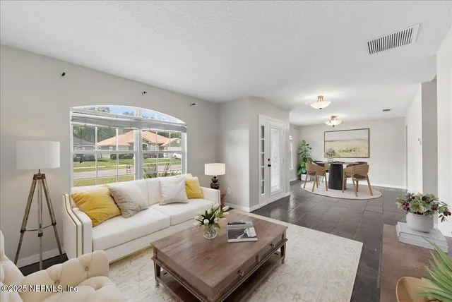 a living room with furniture and a large window