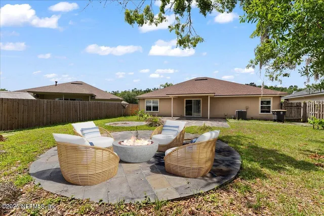 a view of a house with backyard sitting area and swimming pool