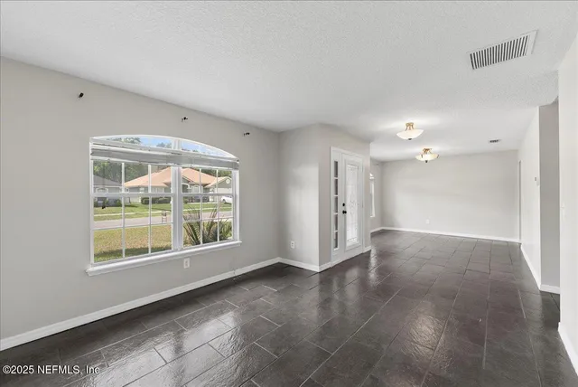 a view of an empty room with a window