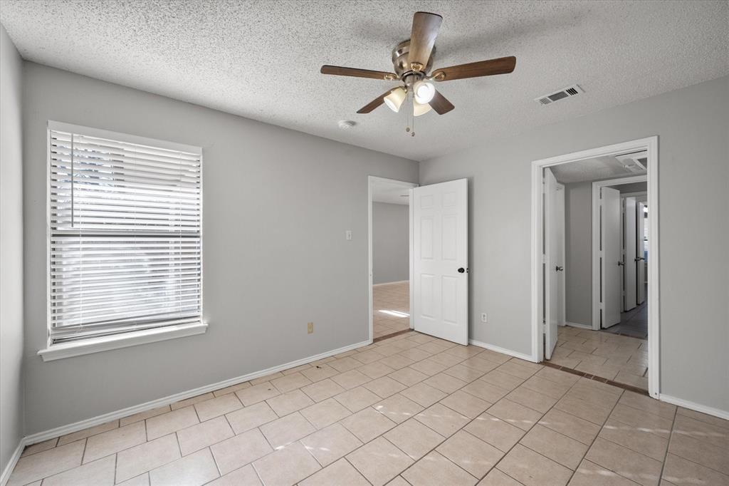 5821 Mansfield Road Arlington, TX 76017 - Photo 21 of 24 a view of a livingroom with a ceiling fan and window