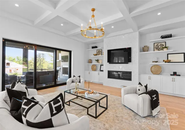 a living room with fireplace furniture and a flat screen tv