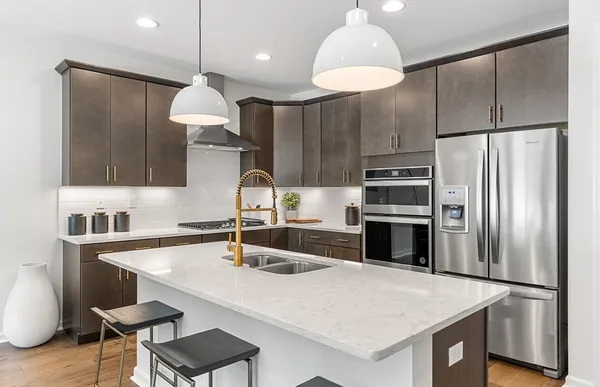 a kitchen with kitchen island a sink stove and refrigerator