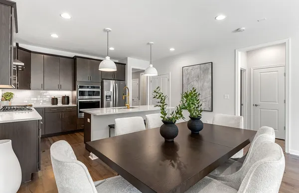 a living room with kitchen island furniture and a chandelier