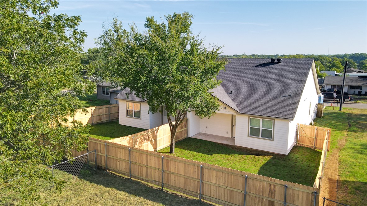 603 North Echols Street, Unit A Caldwell, TX 77836 - Photo 14 of 16 a view of a house with wooden fence