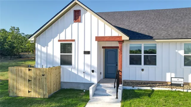 a view of house with backyard
