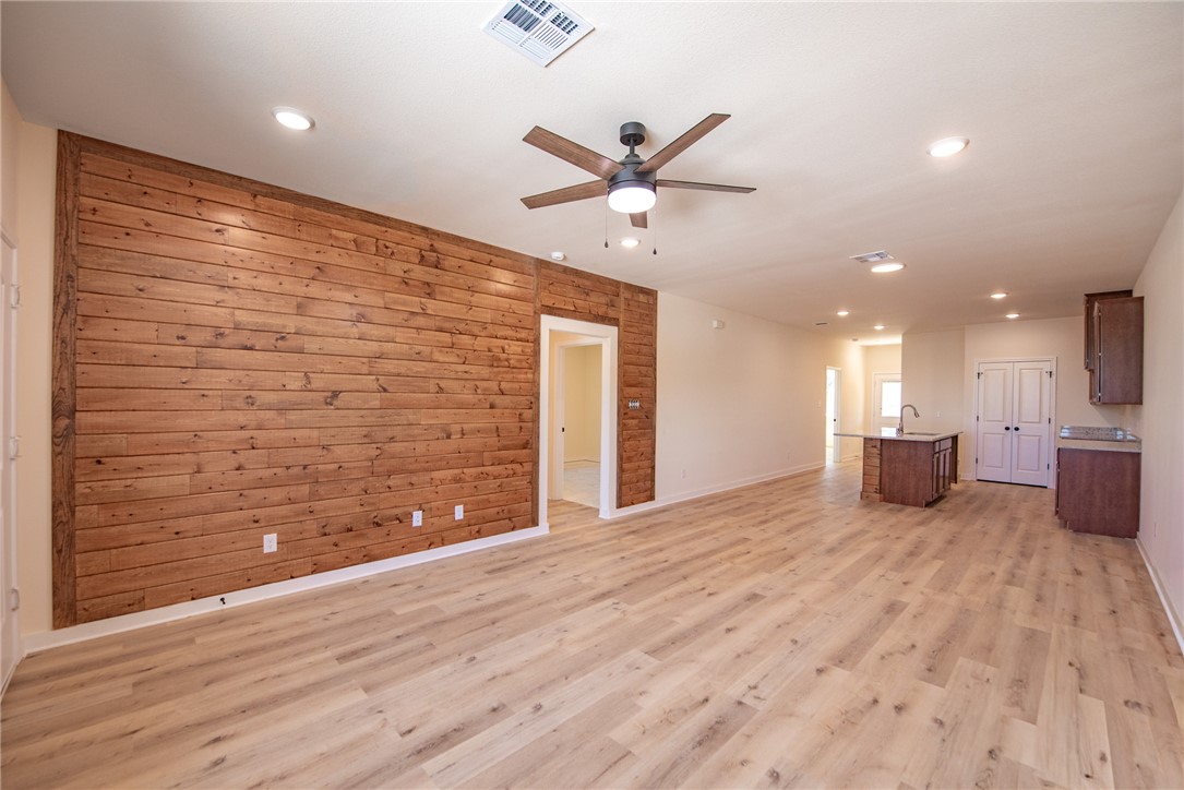 603 North Echols Street, Unit A Caldwell, TX 77836 - Photo 5 of 16 a view of a livingroom with a ceiling fan and wooden floor