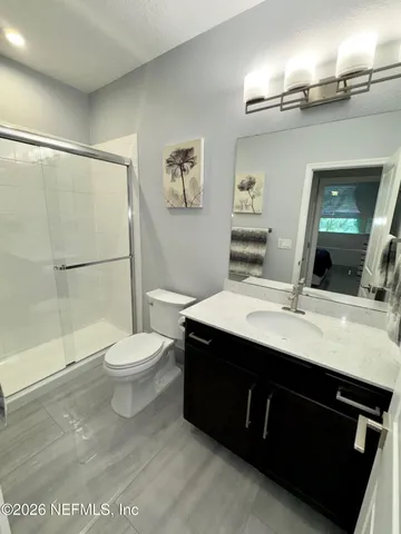 a view of a swimming pool with lawn chairs under an umbrella